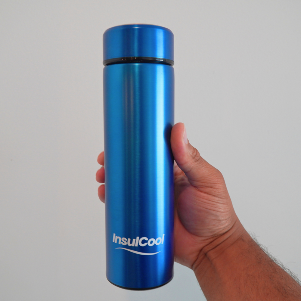 InsulCool Siberian portable insulin cooling case in blue, held in hand